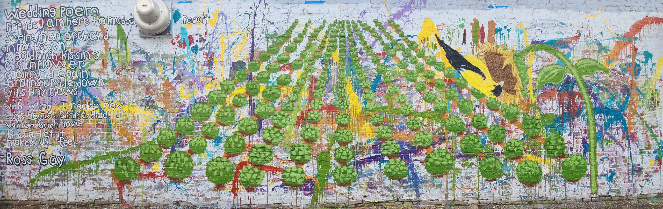 A mural showing text from a poem, many trees, and a sunflower